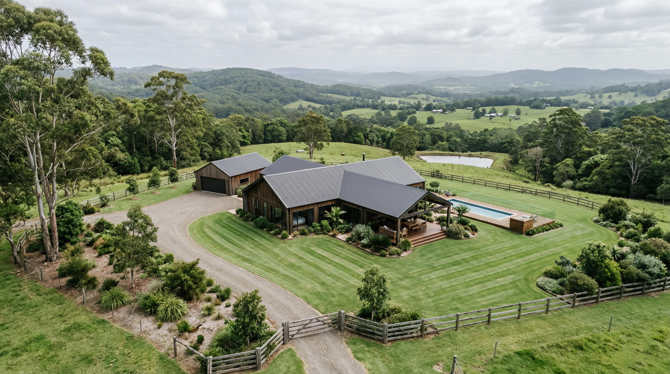 Aerial view of a prestige Byron Bay hinterland property with mowing stripes and rolling green hills