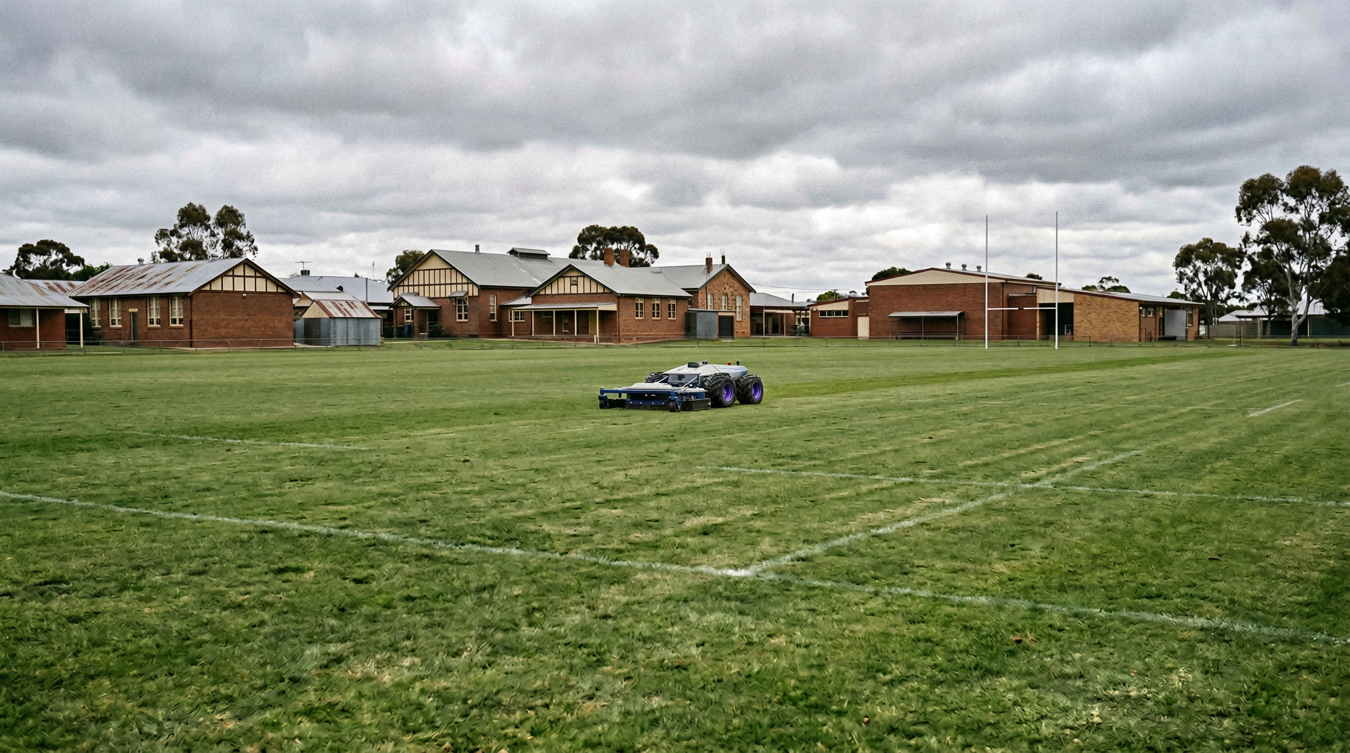 PANDAG G1 on a school oval with rugby posts and brick buildings
